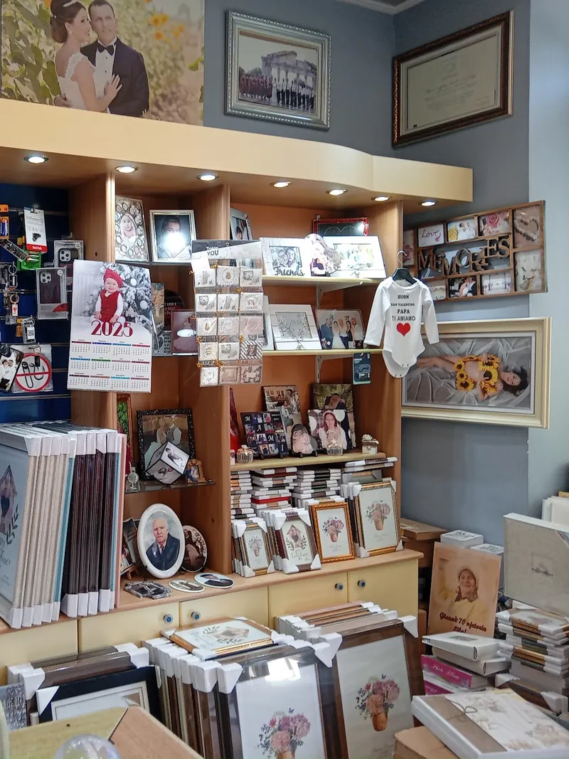 Frames, albums and printed calendars on the studio shelves